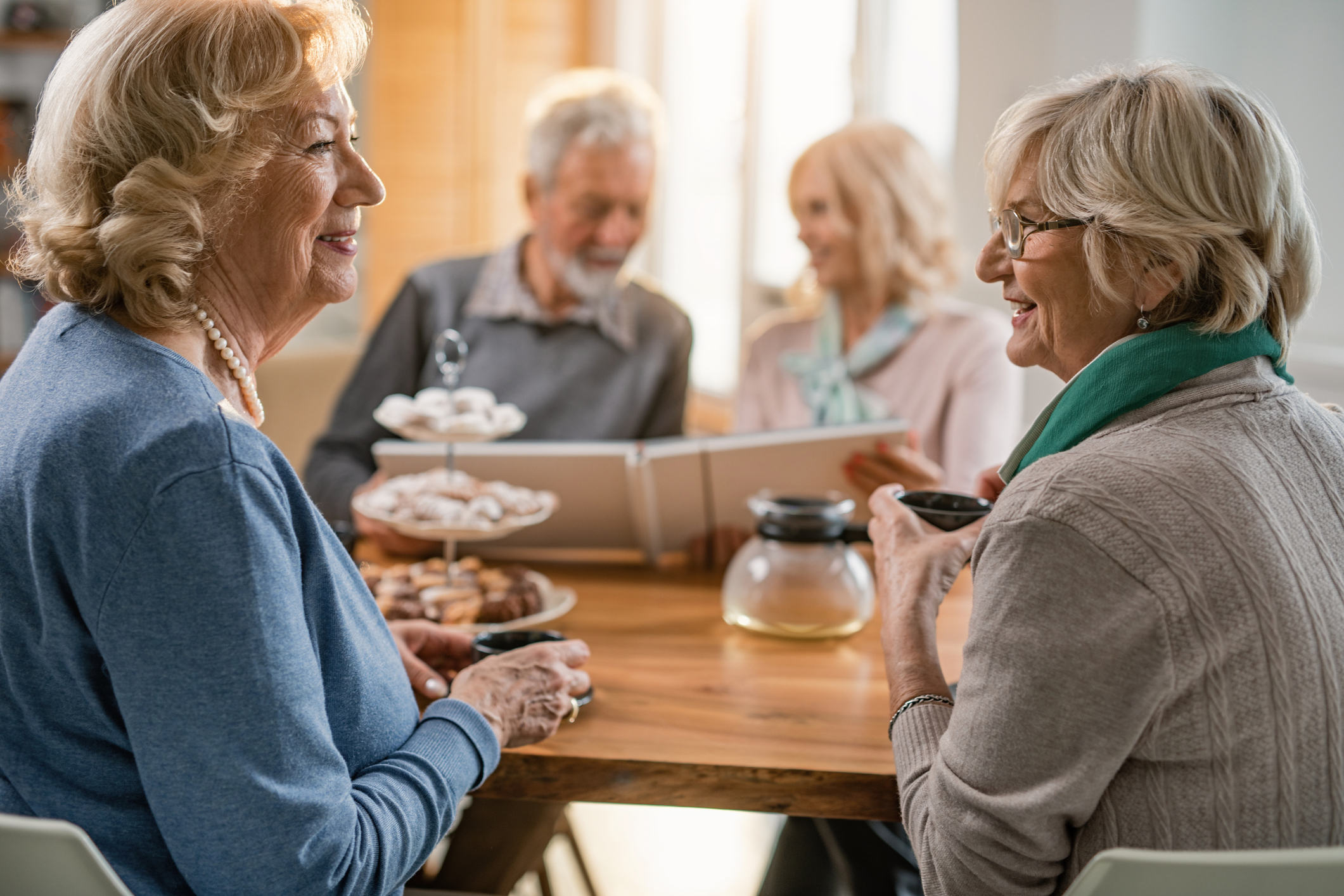 seniors sitting around a table chatting